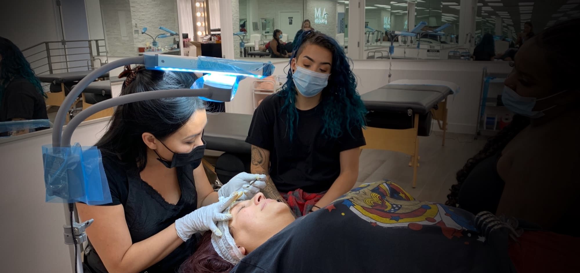 Instructor demonstrating combo brows technique on a student