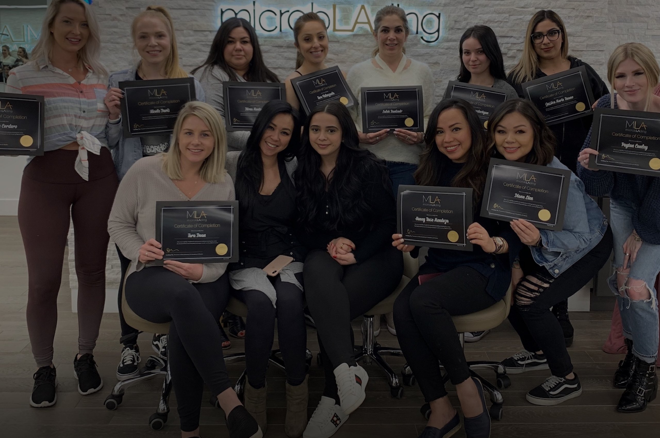 MLA Academy graduates holding certificates of completion