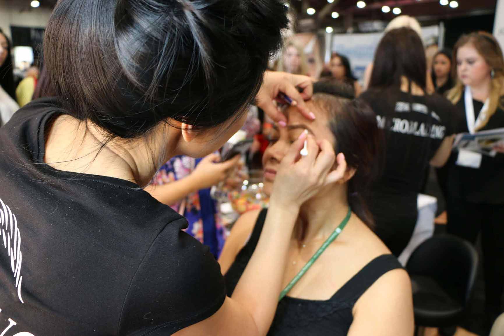 David Zhang performing a live microblading demonstration at the International Beauty Show