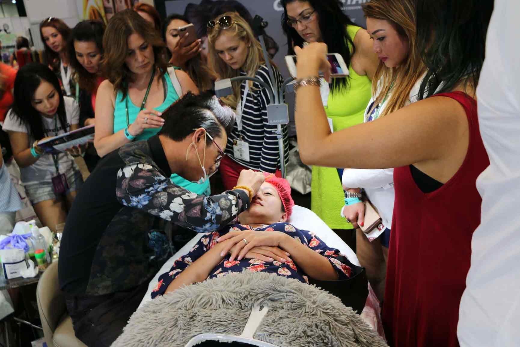 Lindsey Ta performing a live microblading demonstration at the 2016 International Beauty Show booth