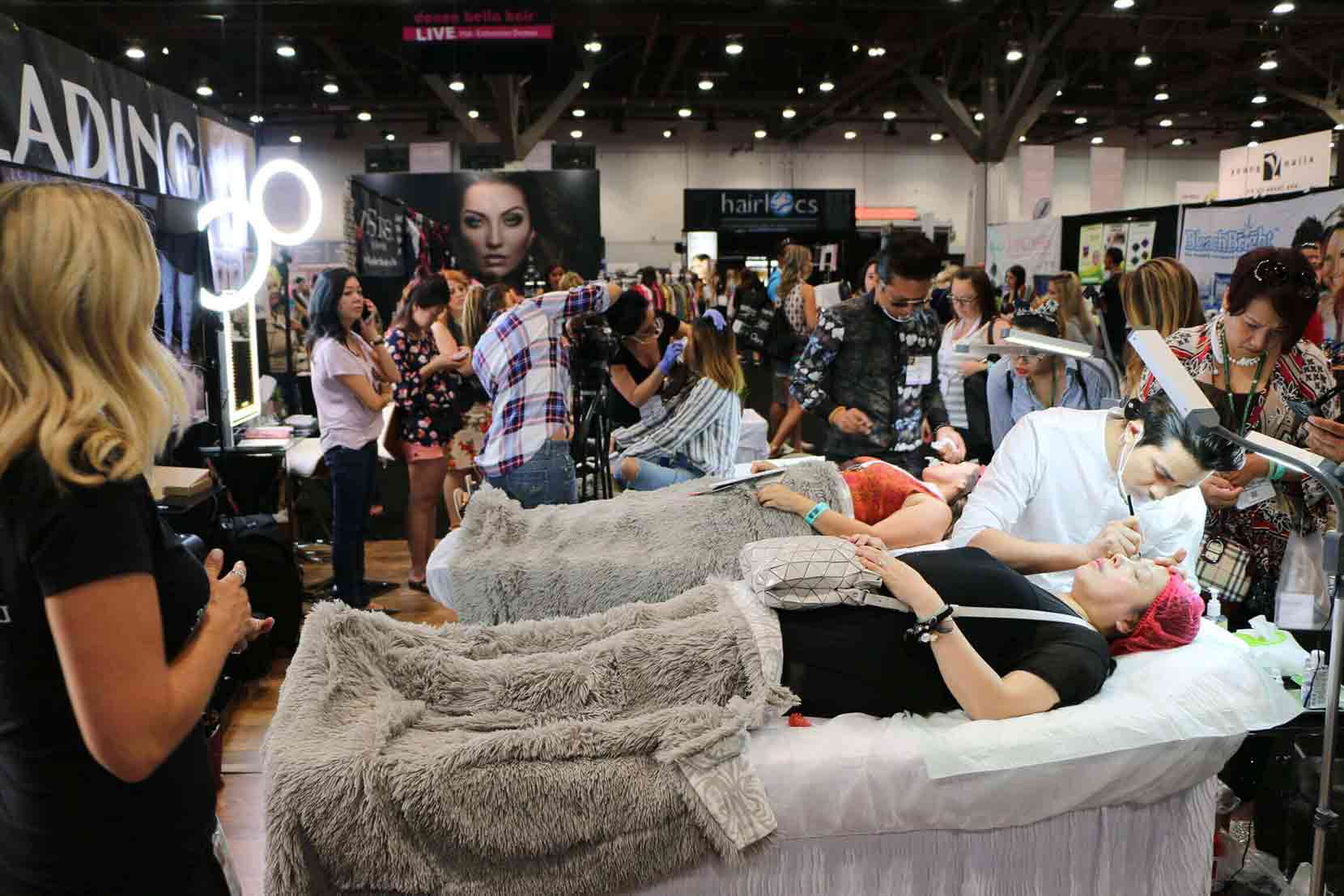 Crowd gathered around the Microblading LA booth watching live demonstrations at IBS 2016