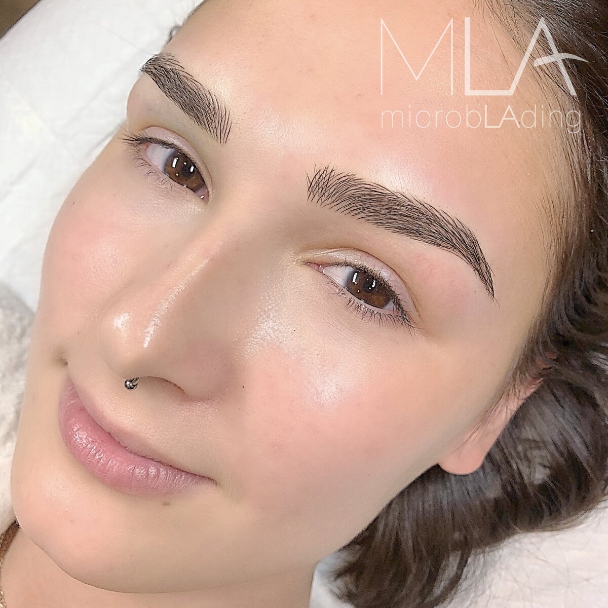 Nano hair-stroke brows on a smiling woman with brown eyes: crisp, natural-looking dark brown brows at Microblading LA