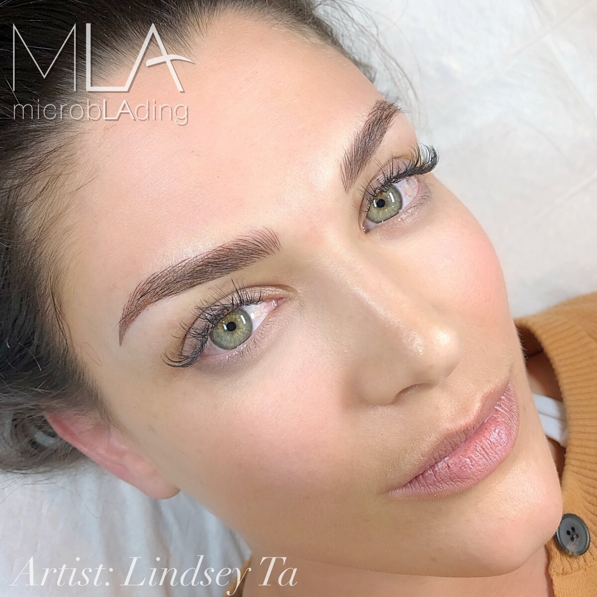 Nano brows results on a woman with green eyes: warm brown hair strokes with a soft arch and tapered tail, at Microblading LA